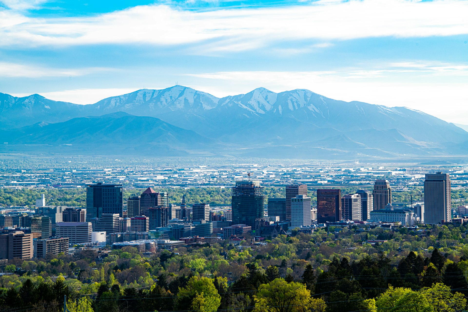 city skyline across green mountain during daytime